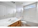 Bright bathroom featuring a single sink vanity, large mirror, and a tub/shower combination at 2715 E Windsor Ave, Phoenix, AZ 85008