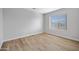 Bedroom offers wood laminate flooring and a large window with horizontal blinds at 2715 E Windsor Ave, Phoenix, AZ 85008