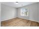 Bedroom with wood laminate flooring and large window for plenty of light at 2715 E Windsor Ave, Phoenix, AZ 85008