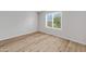 Bedroom features wood laminate flooring, a window, and neutral colored walls at 2715 E Windsor Ave, Phoenix, AZ 85008
