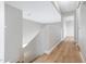 Upstairs hallway with wood laminate flooring, neutral walls, and a staircase at 2715 E Windsor Ave, Phoenix, AZ 85008