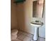 Bathroom featuring tile flooring, a toilet, and pedestal sink at 2912 E Monroe St, Phoenix, AZ 85034