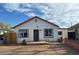 Charming single-story home featuring a red roof, stucco siding, and a small front yard at 2912 E Monroe St, Phoenix, AZ 85034