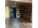 Functional kitchen featuring tiled walls, wooden cabinets, and modern black and white appliances at 2912 E Monroe St, Phoenix, AZ 85034