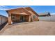 Backyard view of house with covered patio and block wall fence at 31783 N 130Th Ave, Peoria, AZ 85383