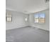 Spacious bedroom with neutral carpet and multiple windows providing ample natural light at 31783 N 130Th Ave, Peoria, AZ 85383