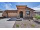 Charming single-story home with a two-car garage, stone accents, and well-maintained landscaping at 31783 N 130Th Ave, Peoria, AZ 85383