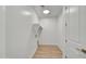 Well-lit laundry room with wood tile floors, a shelf, and hook-ups for appliances at 31783 N 130Th Ave, Peoria, AZ 85383