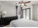 Comfortable bedroom featuring a ceiling fan, dark dresser, and neutral walls at 3333 E Nighthawk Way, Phoenix, AZ 85048