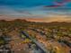 Sunset aerial view of a residential neighborhood nestled in a desert valley with mountain views at 33505 N 25Th Ave, Phoenix, AZ 85085