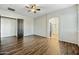 A spacious bedroom shows wood floors and an ensuite bathroom with a sliding barn door at 33505 N 25Th Ave, Phoenix, AZ 85085