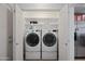 Convenient laundry area with modern washer and dryer, plus ample storage space at 3519 E Erie St, Gilbert, AZ 85295