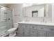 Bathroom featuring a double vanity, shower with glass door, and modern fixtures at 3613 W Camino Real --, Glendale, AZ 85310