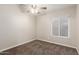 Neutral bedroom featuring carpet flooring, a ceiling fan and a window at 3613 W Camino Real --, Glendale, AZ 85310