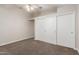 Neutral bedroom featuring carpet flooring, a ceiling fan, and a large closet with sliding doors at 3613 W Camino Real --, Glendale, AZ 85310