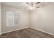 Cozy bedroom featuring a ceiling fan, plush carpet and window with blinds at 3613 W Camino Real --, Glendale, AZ 85310