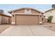 A close up shot of the exterior of the home, highlighting the two car garage and desert landscaping at 3613 W Camino Real --, Glendale, AZ 85310