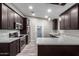 Modern kitchen featuring stainless steel appliances, quartz countertops, dark cabinets, and stylish pendant lighting at 3613 W Camino Real --, Glendale, AZ 85310