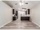 Spacious living area with wood-look floors that seamlessly transitions into the modern kitchen at 3613 W Camino Real --, Glendale, AZ 85310