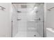 Modern tiled walk-in shower with glass doors, a tiled shower niche and sleek fixtures at 3613 W Camino Real --, Glendale, AZ 85310