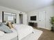 Bright bedroom featuring a plush bed, mirrored closet doors, and a view to a lovely outside at 3825 E Camelback Rd # 292, Phoenix, AZ 85018