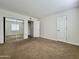Bright bedroom with carpet flooring and sliding mirror closet doors at 3825 E Camelback Rd # 292, Phoenix, AZ 85018