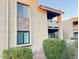 Exterior view of a tan stucco building with brick accent and well-maintained landscaping at 3825 E Camelback Rd # 292, Phoenix, AZ 85018