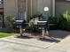 Outdoor community grills with nearby landscaping and well-maintained sidewalk at 3825 E Camelback Rd # 292, Phoenix, AZ 85018