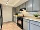 Well-lit kitchen with tile flooring and modern gray cabinets at 3825 E Camelback Rd # 292, Phoenix, AZ 85018