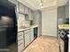 A modern kitchen complete with gray cabinets, stainless steel sink, and black appliances at 3825 E Camelback Rd # 292, Phoenix, AZ 85018