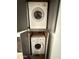 Compact laundry closet featuring stacked washer and dryer, maximizing space and convenience at 3825 E Camelback Rd # 292, Phoenix, AZ 85018