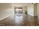 Well-lit living room with tile flooring and a large sliding glass door at 3825 E Camelback Rd # 292, Phoenix, AZ 85018