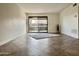 Bright living room featuring tile floors and sliding glass doors to the balcony at 3825 E Camelback Rd # 292, Phoenix, AZ 85018