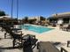 Community pool area with lounge chairs, umbrellas, and well-maintained landscaping at 3825 E Camelback Rd # 292, Phoenix, AZ 85018