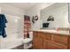 Bathroom features a shower/tub, wooden vanity with granite top, large mirror and artistic wall decorations at 3830 E Lakewood Pkwy # 2116, Phoenix, AZ 85048