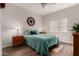 Serene bedroom featuring a bed with teal linens, wood-look floors, and plenty of natural light at 3830 E Lakewood Pkwy # 2116, Phoenix, AZ 85048