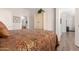 Bedroom featuring a bed with patterned bedspread, wood-look floors, and ample closet space at 3830 E Lakewood Pkwy # 2116, Phoenix, AZ 85048