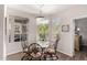 Bright dining room features a glass table, elegant chairs, and sunny windows at 3830 E Lakewood Pkwy # 2116, Phoenix, AZ 85048