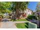 Exterior view of a two-story home shows lush green grass and walkway at 3830 E Lakewood Pkwy # 2116, Phoenix, AZ 85048