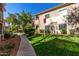 Well-manicured exterior of the building features green grass, a sidewalk, and several trees at 3830 E Lakewood Pkwy # 2116, Phoenix, AZ 85048