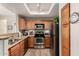 Bright kitchen featuring stainless steel appliances, wood cabinets, and stylish overhead lighting at 3830 E Lakewood Pkwy # 2116, Phoenix, AZ 85048