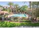 Relaxing pool area surrounded by palm trees, lounge chairs, and well-maintained landscaping at 3830 E Lakewood Pkwy # 2116, Phoenix, AZ 85048