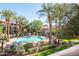 Inviting pool area with lush landscaping, palm trees, and lounge chairs at 3830 E Lakewood Pkwy # 2116, Phoenix, AZ 85048
