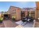 Exterior patio area with dining table, chairs, rug, BBQ grill, and desert landscaping under a clear blue sky at 3964 N Hawthorn Dr, Florence, AZ 85132