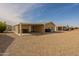 Back of the house features a gravel yard, covered patio, and satellite dish at 40569 N Wedge Dr, San Tan Valley, AZ 85140