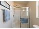 Bathroom showcasing a tiled shower with glass doors and bright lighting at 40569 N Wedge Dr, San Tan Valley, AZ 85140