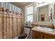 Bathroom featuring a decorative shower curtain, vanity, and window at 40569 N Wedge Dr, San Tan Valley, AZ 85140