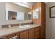 Bathroom featuring a vanity with storage, a mirror and a door at 40569 N Wedge Dr, San Tan Valley, AZ 85140
