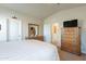 Bedroom featuring a dresser with a large mirror, neutral walls, and doorways at 40569 N Wedge Dr, San Tan Valley, AZ 85140