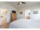 Bedroom featuring wood floors, a tv, artwork and doorways at 40569 N Wedge Dr, San Tan Valley, AZ 85140